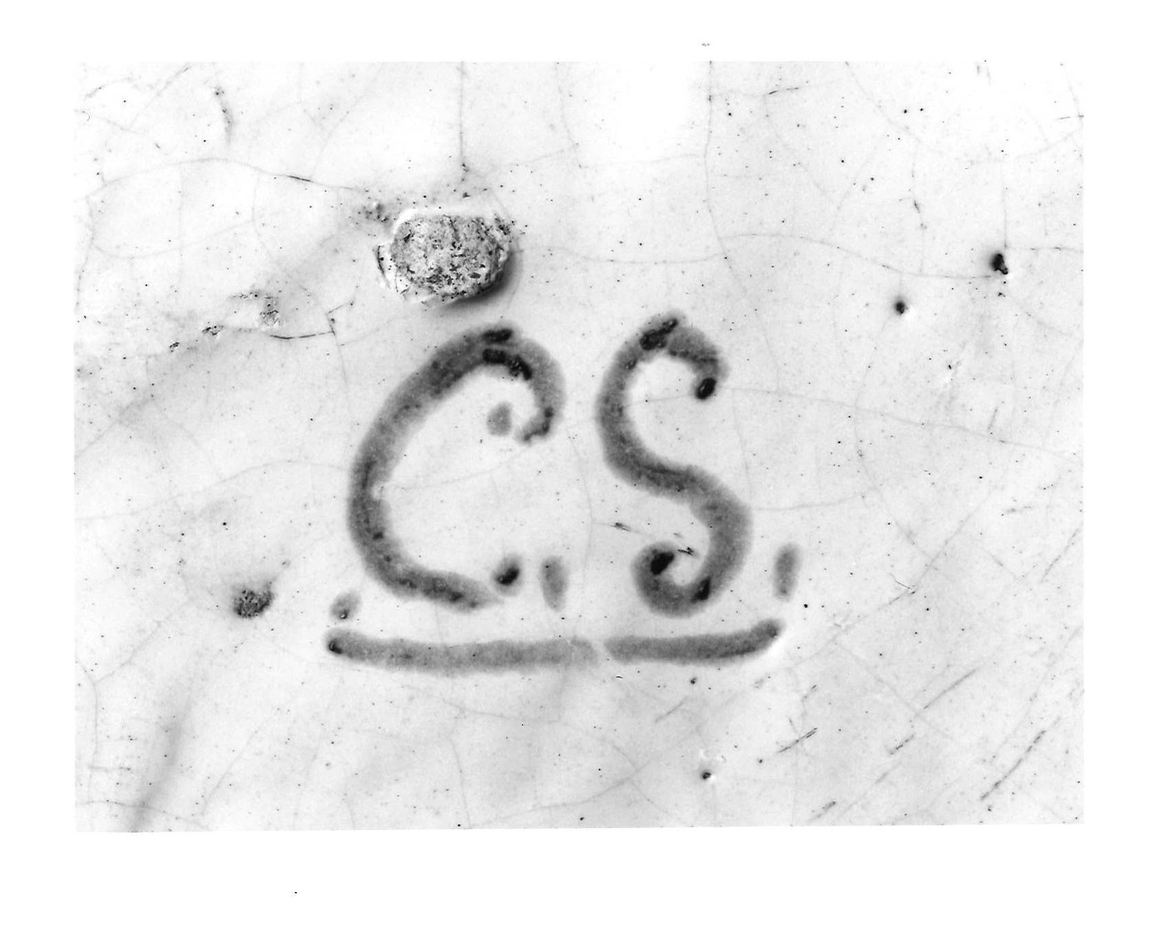 A close-up view of a white vessel marked with C.S.