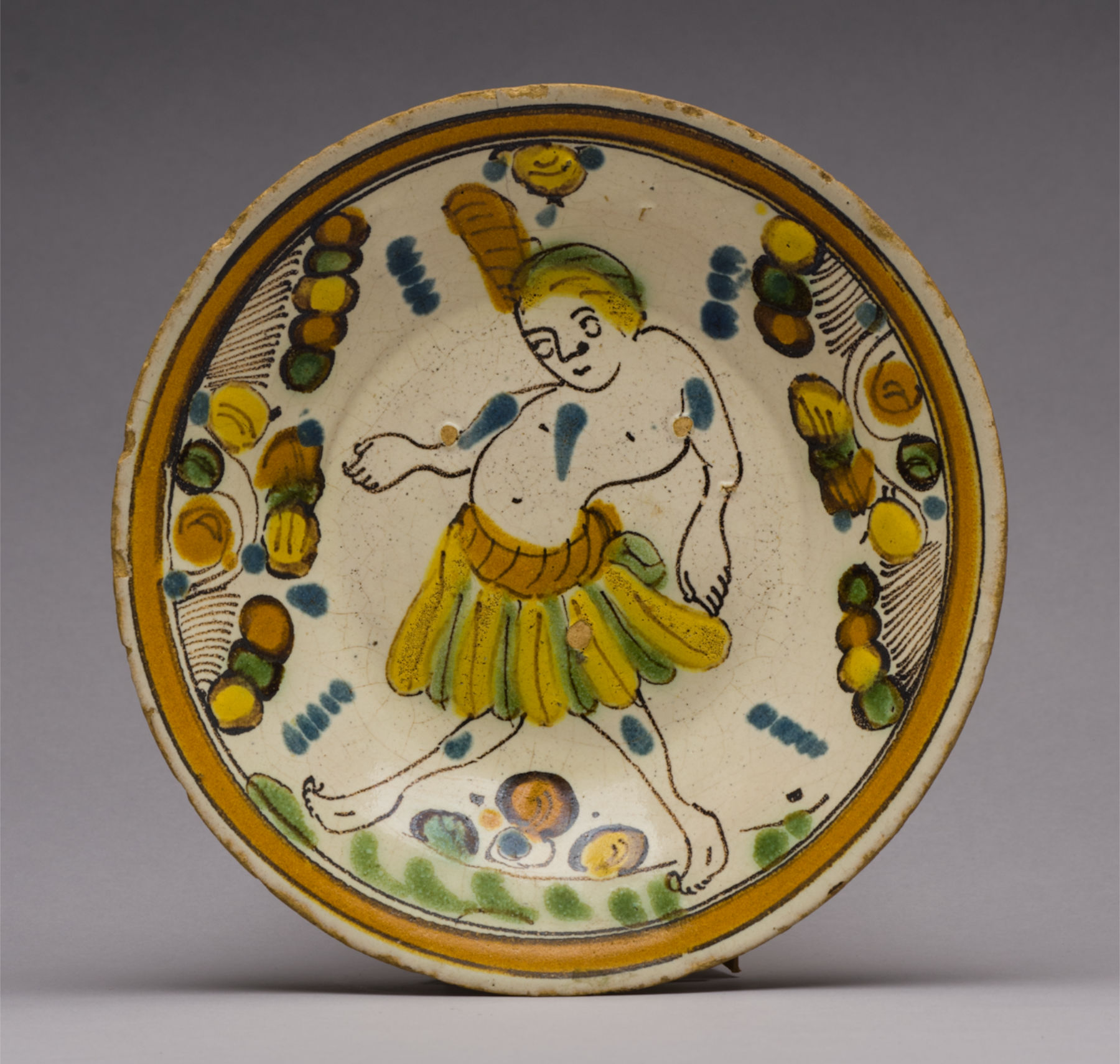 A cream vessel with orange-brown, yellow, green, and blue circle motifs surrounding an image of a person wearing a mid-length skirt.