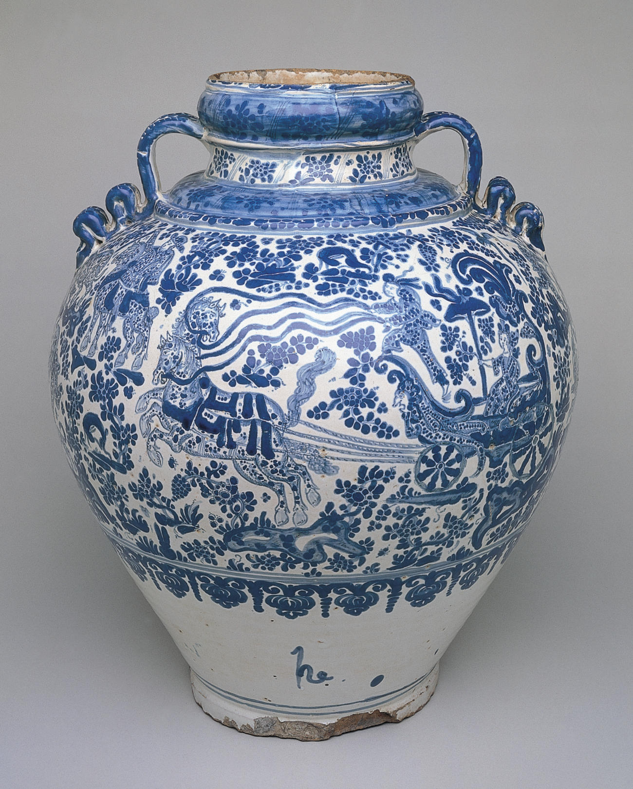 A white bulbous vessel featuring blue imagery of a pair of horses drawing a carriage with a woman