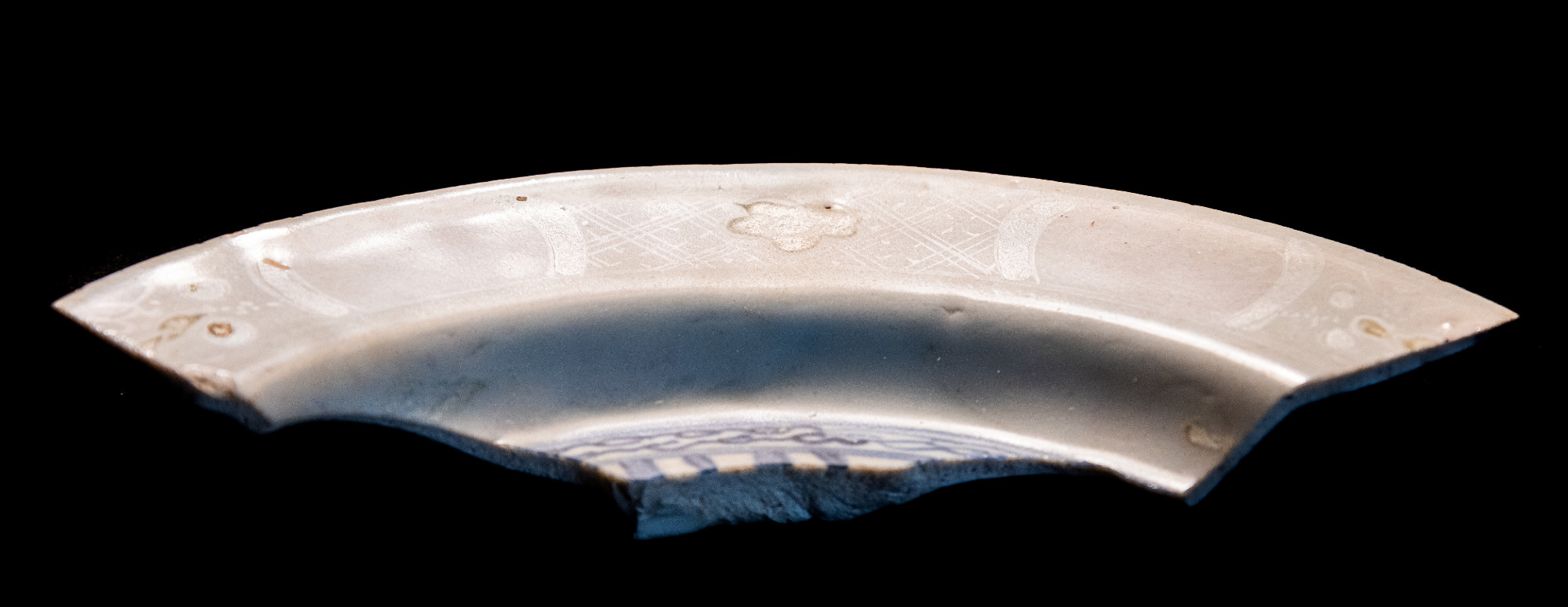 A shard of the rim of a plate or bowl.
