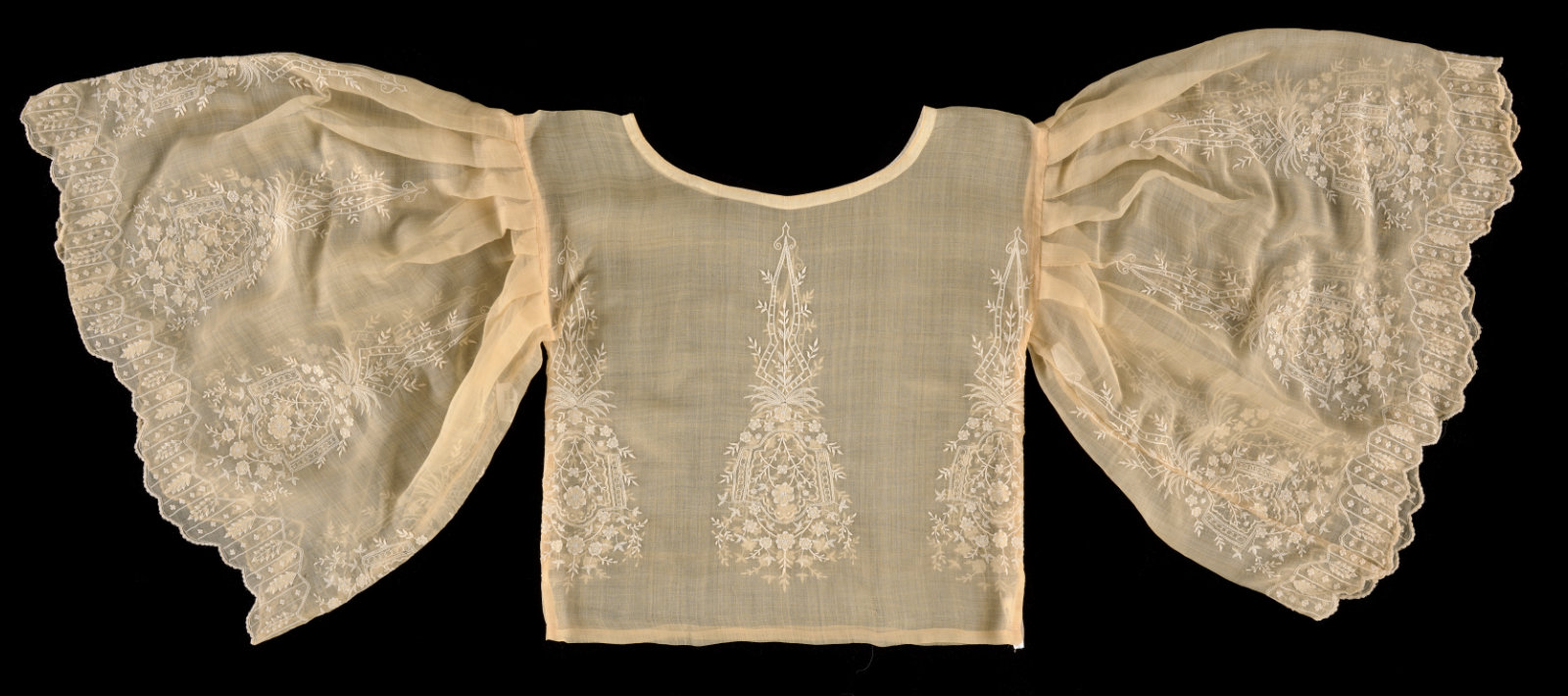 An ivory colored blouse with very poofy sleeves.