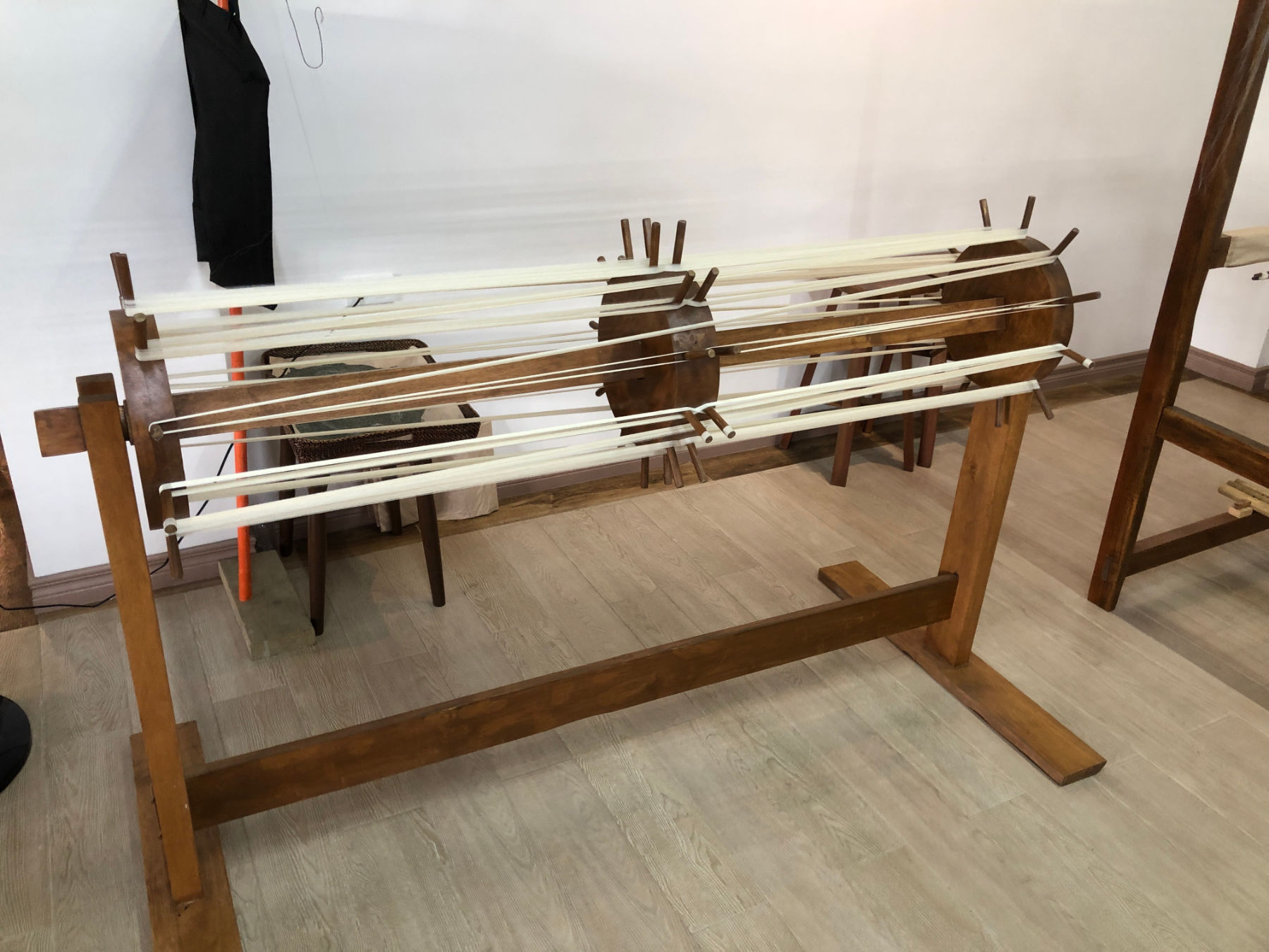 A photograph of a wooden loom.