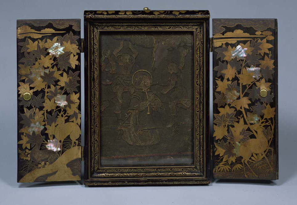 A photo of a winged altar with leaf decoration on the doors and a central scene of a kneeling man about to be pelted with stones.