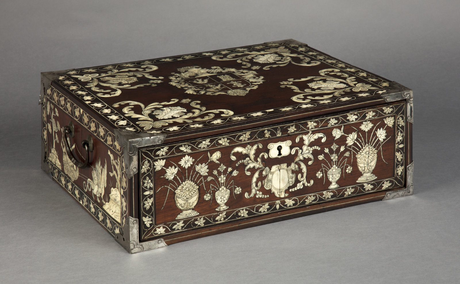 A wooden box with inlaid floral imagery.