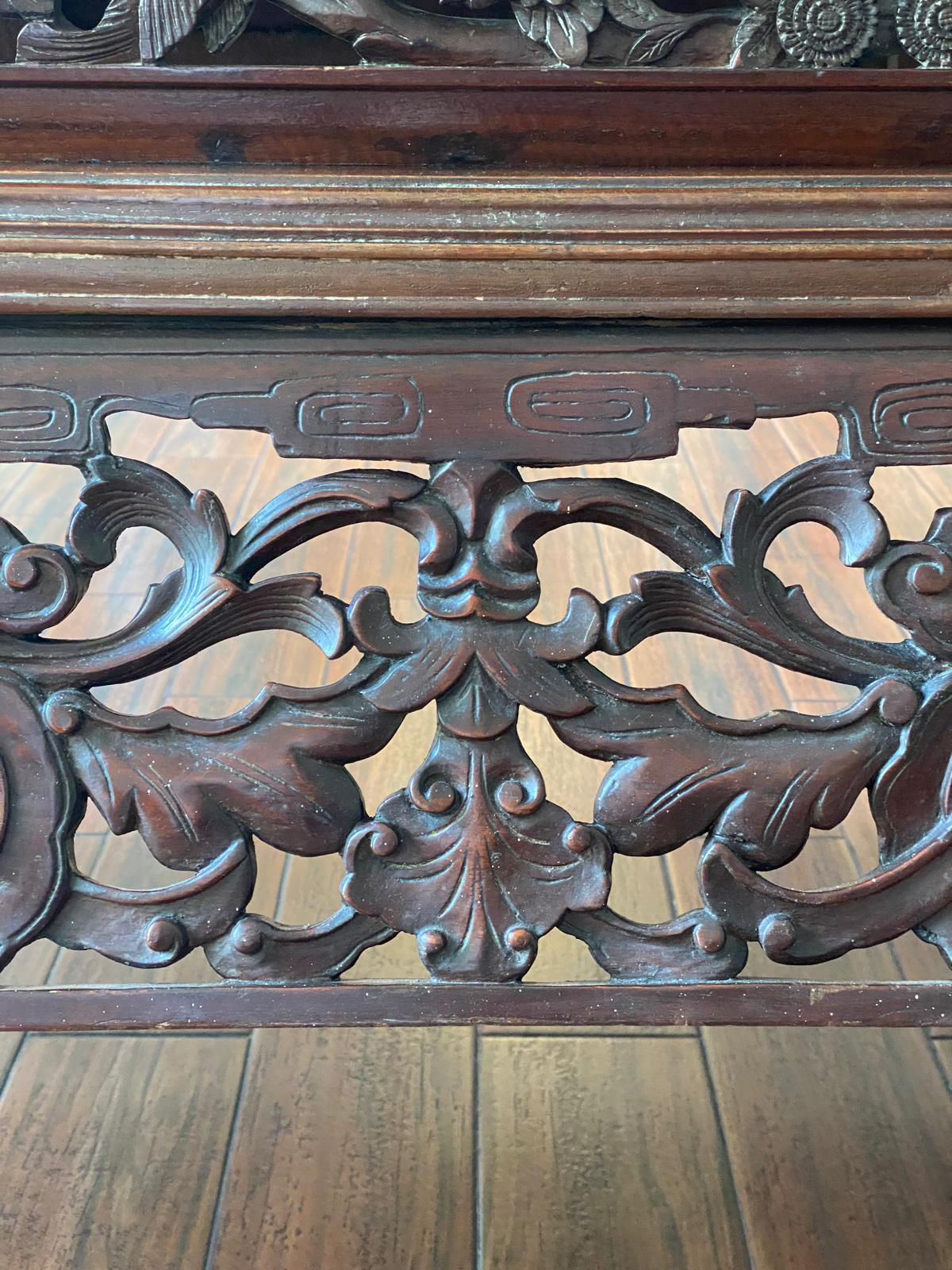 Close-up view of vegetal motifs on a wooden altar table.