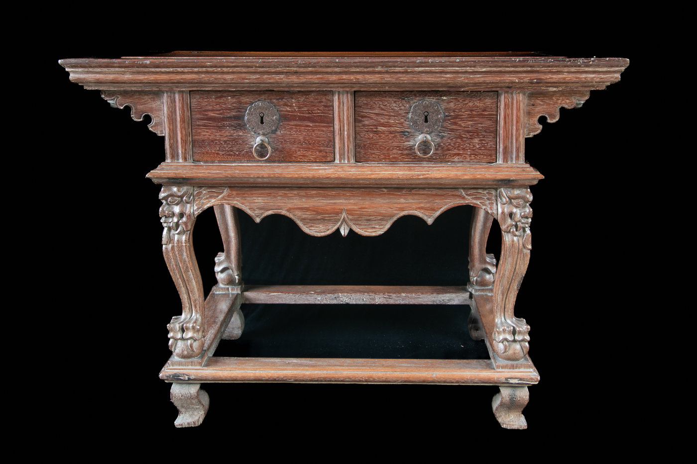 Wooden cabinet with legs that feature paws holding balls.