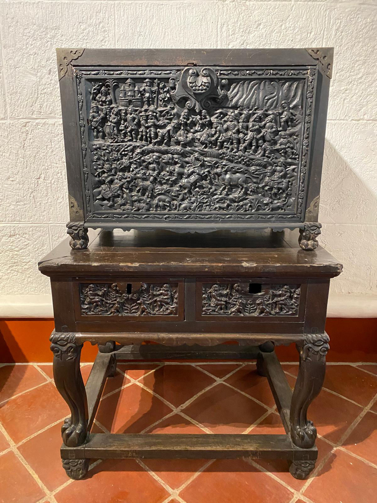 An ornately decorated wooden cabinet.