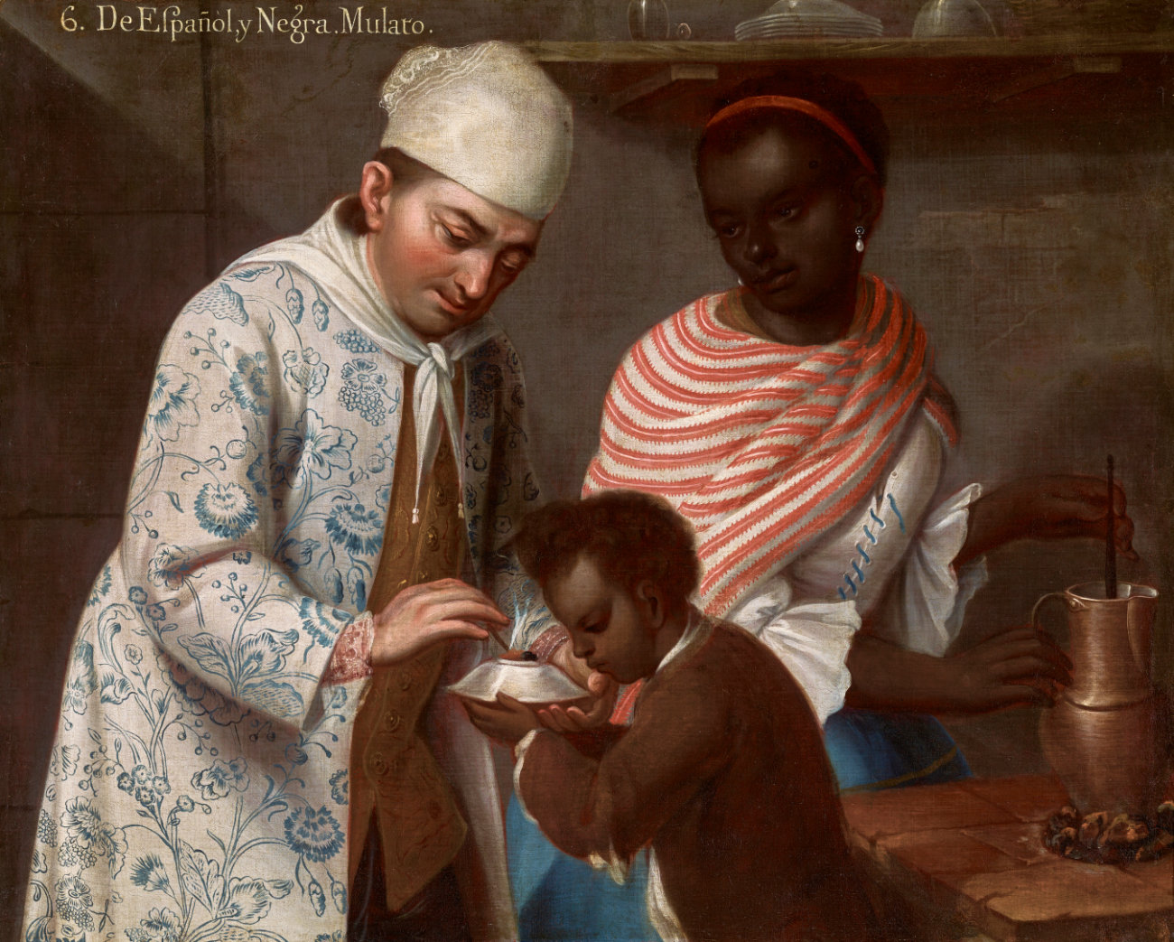 A light-skinned man and dark-skinned woman interact with a young mixed-race boy.
