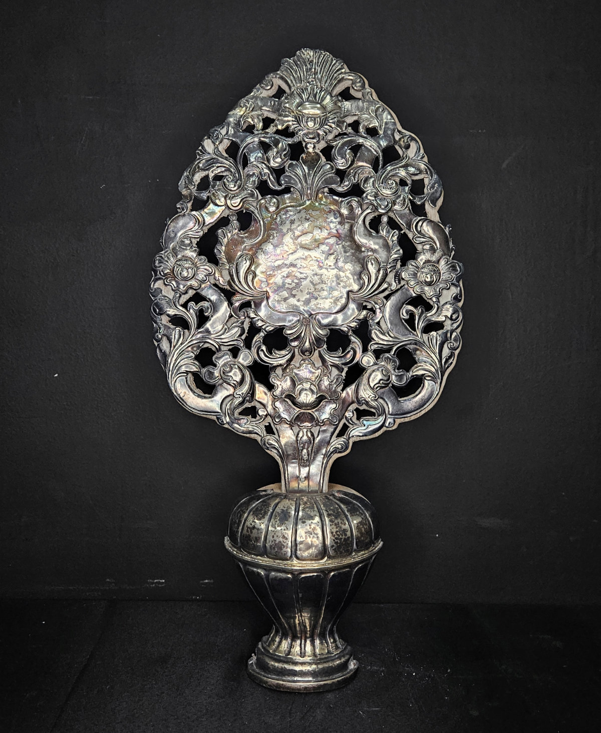 A silver floral ornament.