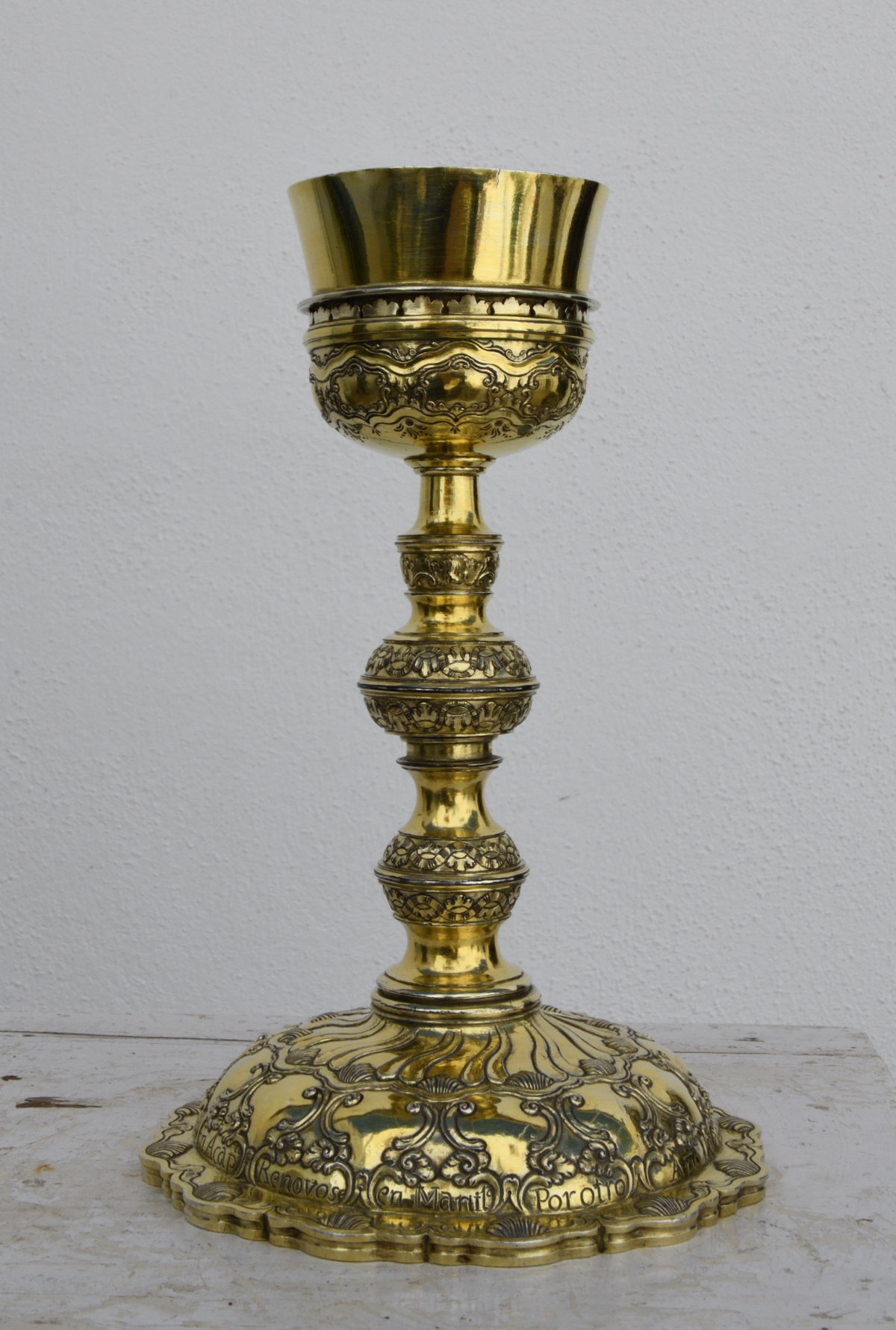 A silver gilt chalice with a round base.